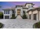 Beautiful two-story home with manicured landscaping, double garage, brick driveway, and elegant entrance at 1333 Vista Dr, Sarasota, FL 34239
