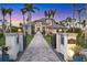 Elegant home showcasing a grand entrance, palm trees, manicured landscaping, and beautiful brick driveway at 1333 Vista Dr, Sarasota, FL 34239