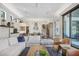 Open-concept living room with a modern kitchen, plush sofa, and access to an outdoor patio at 1333 Vista Dr, Sarasota, FL 34239