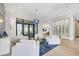 Spacious living room with contemporary decor, water views, eye-catching chandelier, and glass wine storage at 1333 Vista Dr, Sarasota, FL 34239