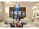 Bright living room featuring modern decor, comfortable seating, water views, and unique glass chandelier at 1333 Vista Dr, Sarasota, FL 34239