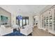 Bright living room with water views, stylish chandelier, comfortable seating and a unique glass wine rack at 1333 Vista Dr, Sarasota, FL 34239