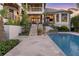 Backyard with pool, patio, tropical landscaping, and steps leading up to the home at 1333 Vista Dr, Sarasota, FL 34239