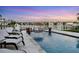 Relaxing pool with lounge chairs, tiki umbrella, and stunning waterfront views at 1333 Vista Dr, Sarasota, FL 34239