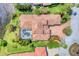 Aerial view of the estate with a private pool, tile roof, landscaping, and proximity to a serene lake at 13708 Red Rock Pl, Lakewood Ranch, FL 34202