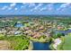 Extensive aerial view showing the community, lush greenery, lakes and golf course at 13708 Red Rock Pl, Lakewood Ranch, FL 34202