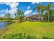 Spacious backyard overlooking the water with lawn, screened-in lanai, and seating at 13708 Red Rock Pl, Lakewood Ranch, FL 34202