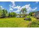 Beautiful backyard view featuring lawn, water view, and outdoor seating at 13708 Red Rock Pl, Lakewood Ranch, FL 34202