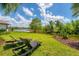 Relaxing backyard featuring lounge chairs and a scenic water view on a sunny day at 13708 Red Rock Pl, Lakewood Ranch, FL 34202
