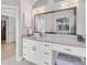 Bathroom featuring granite countertops, white cabinetry, a vanity, and a large mirror at 13708 Red Rock Pl, Lakewood Ranch, FL 34202