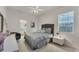 Neutral-toned bedroom with window, ceiling fan, and door to bathroom at 13708 Red Rock Pl, Lakewood Ranch, FL 34202