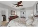 Bright bedroom with a ceiling fan, workspace, and ample closet space at 13708 Red Rock Pl, Lakewood Ranch, FL 34202