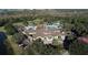 Aerial view of the community clubhouse featuring a swimming pool and recreation area surrounded by trees and parking at 13708 Red Rock Pl, Lakewood Ranch, FL 34202