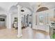 Grand foyer featuring tile flooring, soaring ceilings, arched doorways, and elegant lighting at 13708 Red Rock Pl, Lakewood Ranch, FL 34202
