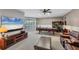 Spacious game room with ping pong table, a large TV, a leather couch and access to the outdoors at 13708 Red Rock Pl, Lakewood Ranch, FL 34202