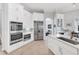 Modern kitchen with stainless steel appliances, custom cabinets, and tile flooring at 13708 Red Rock Pl, Lakewood Ranch, FL 34202