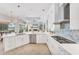 Contemporary kitchen with white cabinetry, stainless steel appliances, and a view to the backyard at 13708 Red Rock Pl, Lakewood Ranch, FL 34202