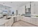 Bright kitchen features white cabinets, stainless steel appliances, and stylish backsplash at 13708 Red Rock Pl, Lakewood Ranch, FL 34202