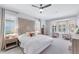 Spacious main bedroom with a decorative headboard, plantation shutters, and bay window seating at 13708 Red Rock Pl, Lakewood Ranch, FL 34202