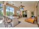 Outdoor kitchen featuring granite countertops, bar seating, a built-in grill, and an adjacent seating area at 13708 Red Rock Pl, Lakewood Ranch, FL 34202