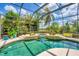 Enjoy the beautiful lake view from this large, screened pool with spa and mature landscaping at 13708 Red Rock Pl, Lakewood Ranch, FL 34202