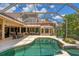 Screened-in pool area features a kidney-shaped pool, spa, and plenty of space for seating and entertaining at 13708 Red Rock Pl, Lakewood Ranch, FL 34202