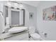 Modern powder room with a unique vessel sink, granite countertop, and decorative accents at 13708 Red Rock Pl, Lakewood Ranch, FL 34202