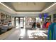 Pro shop with tennis equipment, clothing racks, and a view of the pool area for a convenient shopping experience at 13708 Red Rock Pl, Lakewood Ranch, FL 34202
