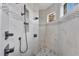 Elegant walk-in shower features marble tiling, rain shower head, and built-in shelves at 13708 Red Rock Pl, Lakewood Ranch, FL 34202