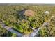 Overhead view showcasing a private home surrounded by lush greenery and wooded areas at 13955 Pine Woods E Ln, Sarasota, FL 34240
