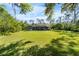 Spacious backyard featuring an enclosed lanai with screened pool, perfect for outdoor living at 13955 Pine Woods E Ln, Sarasota, FL 34240