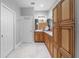 Bathroom with wood cabinets, dual sinks and linen closet at 13955 Pine Woods E Ln, Sarasota, FL 34240