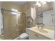 Clean bathroom featuring a glass-enclosed shower, vanity, and ample storage at 13955 Pine Woods E Ln, Sarasota, FL 34240