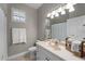 Bright bathroom featuring a large mirror, vanity and towel rack at 13955 Pine Woods E Ln, Sarasota, FL 34240
