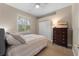 Well-lit bedroom with a window, closet and dresser at 13955 Pine Woods E Ln, Sarasota, FL 34240