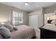 Cozy bedroom with soft lighting, plush pillows, and a view into the connected dressing room at 13955 Pine Woods E Ln, Sarasota, FL 34240