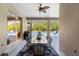 Covered patio features stylish outdoor dining furniture and views of the screened pool area at 13955 Pine Woods E Ln, Sarasota, FL 34240
