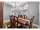Formal dining room featuring a large table with seating for eight, chandelier, and views through an arched doorway at 13955 Pine Woods E Ln, Sarasota, FL 34240