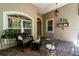 Comfortable front porch area featuring neutral tones, brick flooring, and stylish outdoor seating at 13955 Pine Woods E Ln, Sarasota, FL 34240