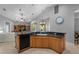 Bright kitchen featuring wood cabinets, granite countertops, and stainless steel appliances, creating a modern space at 13955 Pine Woods E Ln, Sarasota, FL 34240