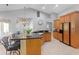 Open kitchen featuring wood cabinets, granite countertops, bar stool seating, and stainless steel appliances at 13955 Pine Woods E Ln, Sarasota, FL 34240