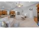 Bright living area with open floor plan, neutral decor, tile flooring, and seamless transitions to adjacent spaces at 13955 Pine Woods E Ln, Sarasota, FL 34240