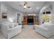 Inviting living room with comfortable white sofas, media center, ceiling fan, and neutral decor at 13955 Pine Woods E Ln, Sarasota, FL 34240