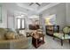 Open living space with large windows providing natural light, connected to dining area with a buffet at 13955 Pine Woods E Ln, Sarasota, FL 34240