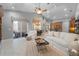 Open-concept living area with tile flooring, modern furnishings, and seamless flow to the kitchen and dining space at 13955 Pine Woods E Ln, Sarasota, FL 34240
