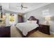 Tranquil main bedroom with tray ceiling, slider to pool, and sophisticated furnishings for rest and relaxation at 13955 Pine Woods E Ln, Sarasota, FL 34240