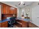 Office area boasts custom wood cabinetry, plenty of workspace and views at 13955 Pine Woods E Ln, Sarasota, FL 34240