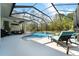 Inviting screened-in pool area with comfortable lounge chairs and tranquil backyard views at 13955 Pine Woods E Ln, Sarasota, FL 34240