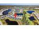 Aerial view of a community with homes surrounded by scenic lakes and a golf course at 15039 Black Cherry Way, Punta Gorda, FL 33955
