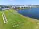 Aerial view of the community driving range and lake in a Primary planned community with beautiful landscaping at 15039 Black Cherry Way, Punta Gorda, FL 33955